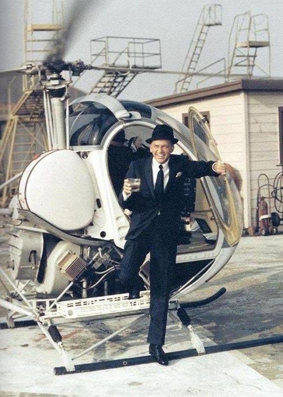 Fran Sinatra climbing out of a helicopter without spilling a drop. 1960s.jpg