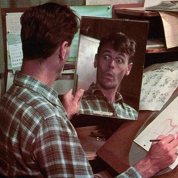 In order to get characters facial expressions right, Disney animators, such as Wolfgang Woolie Reitherman pictured below, study their own reflections in the mirror, 1940s.jpg