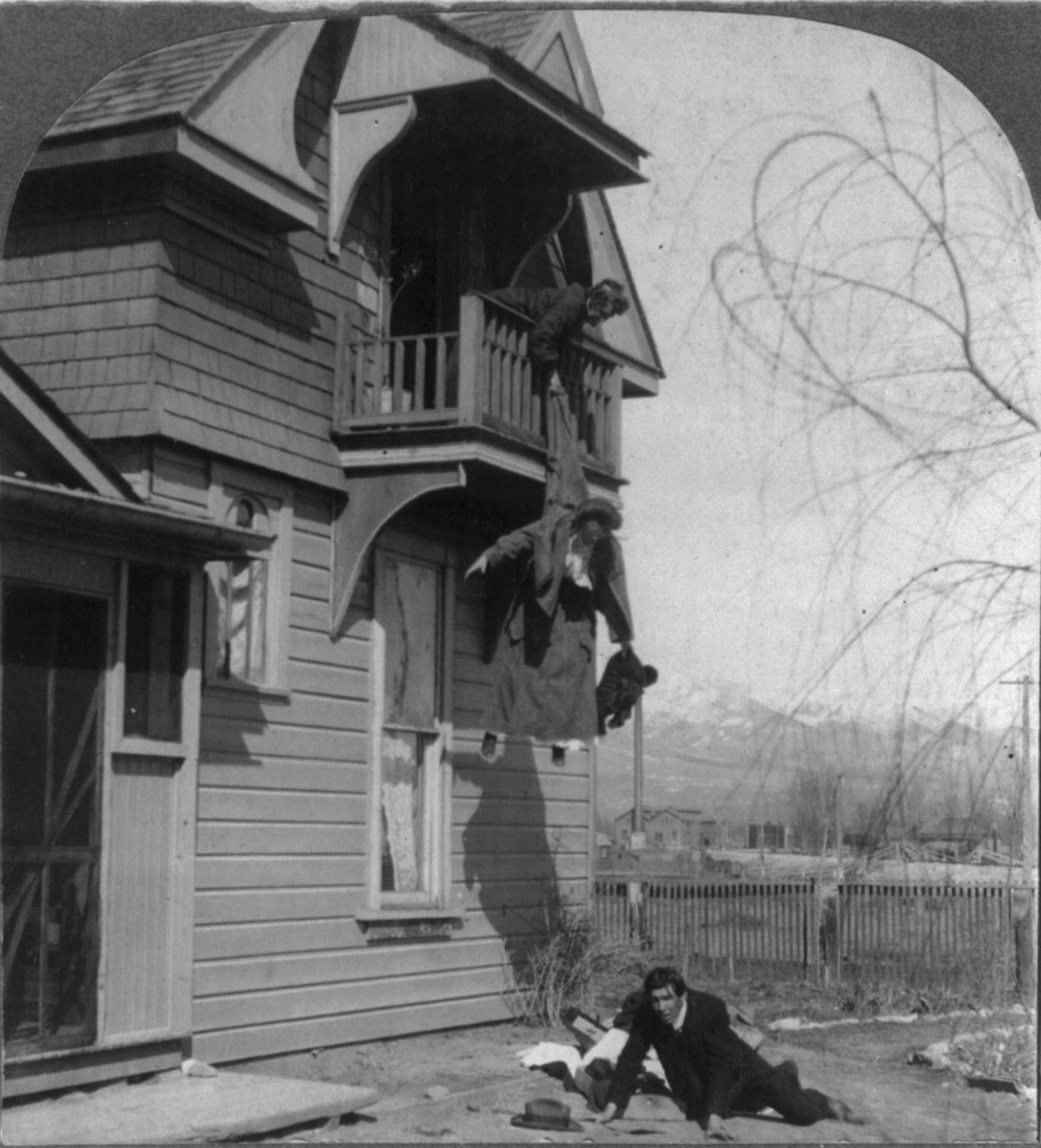 Humorous scene of old woman preventing young woman from elopement by holding her by the coat as she is jumping off balcony, 1905.jpg