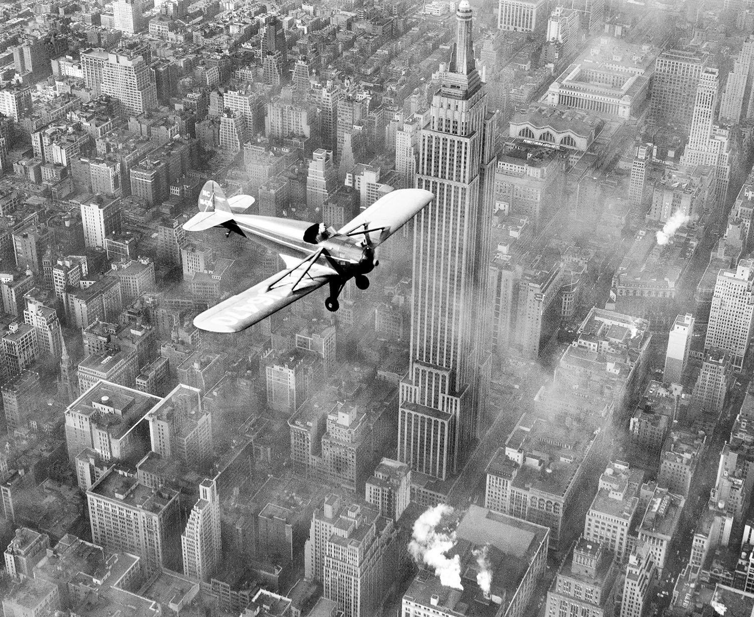 Ted Herbert, in his plane powered by a V-8 automobile engine, over midtown Manhattan in February 1937.jpg