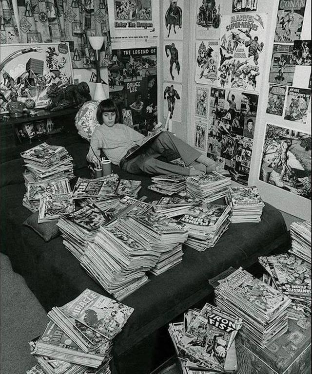 A teenager in his room surrounded by his immense comics collection, 1970s.jpg