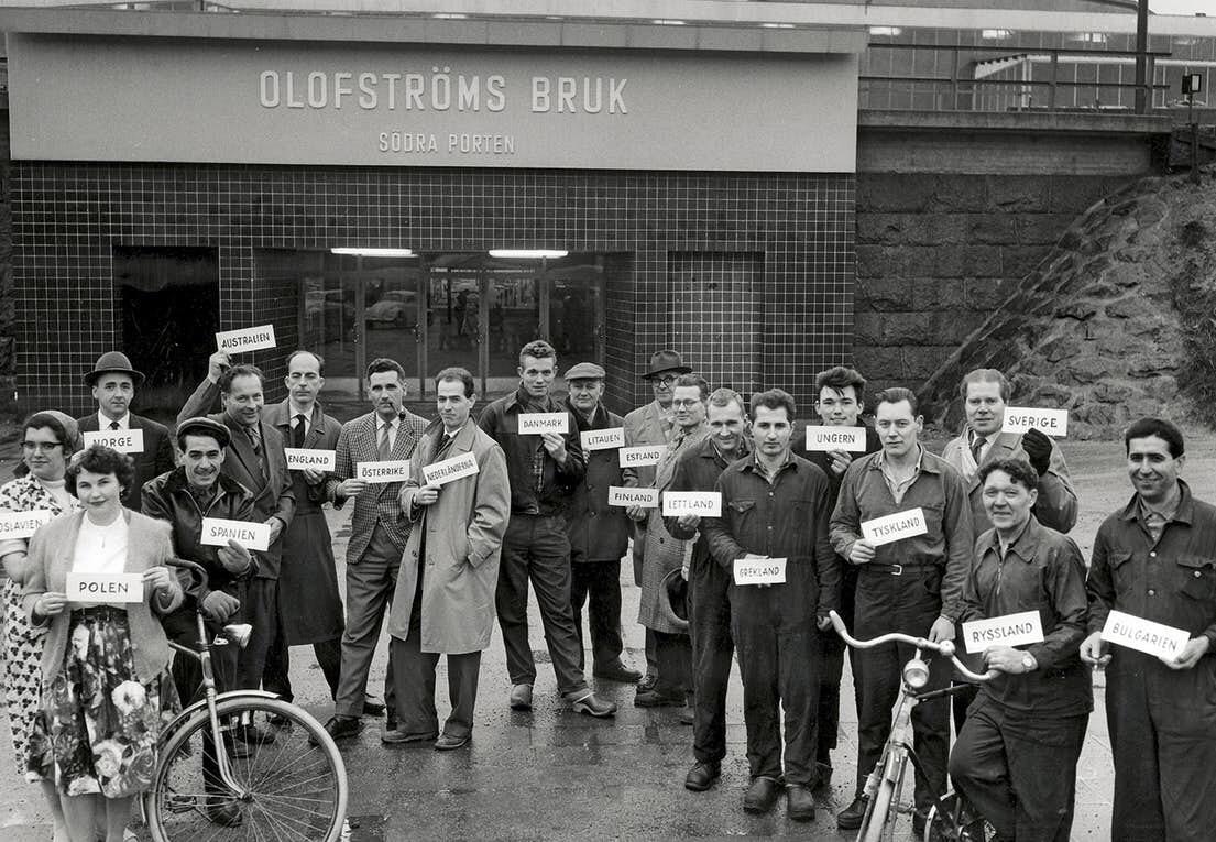 Working immigrants in Sweden holding up signs with their country of origin (1960s).jpg