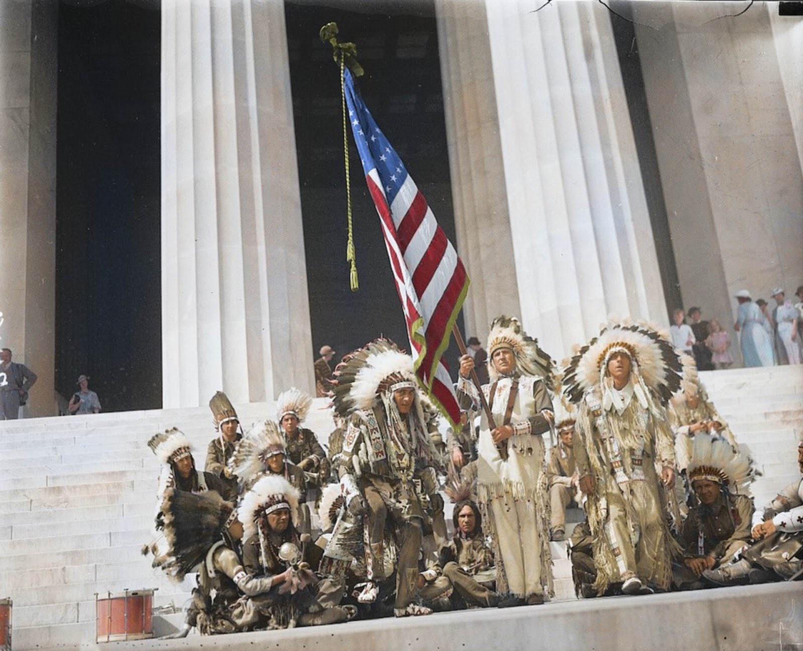 1936. Native American men wearing their traditional attire while raising the Stars and Stripes at the Lincoln Memorial. 12 years after President Calvin Coolidge granted them US citizenship.jpg
