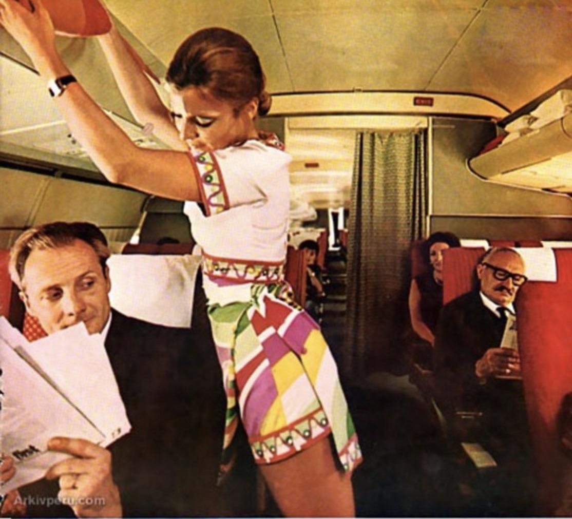 Braniff stewardess, 1970s. (When I typed Braniff, my phone tried to autocorrect to Bra off)..jpg