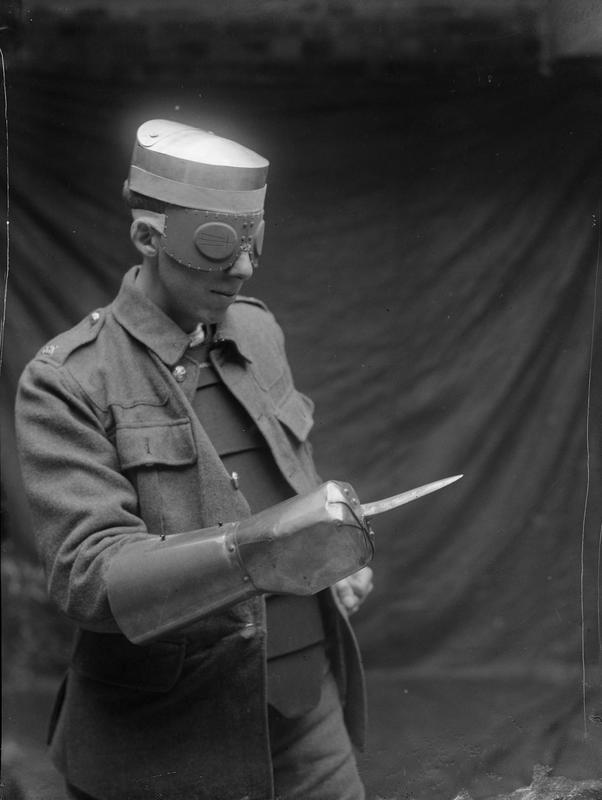 A World War I soldier wearing a steel armor cap (worn under the regular ordinance cap), splinter goggles to protect the eyes from shrapnel, and a steel dagger gauntlet, ca. 1917.jpg