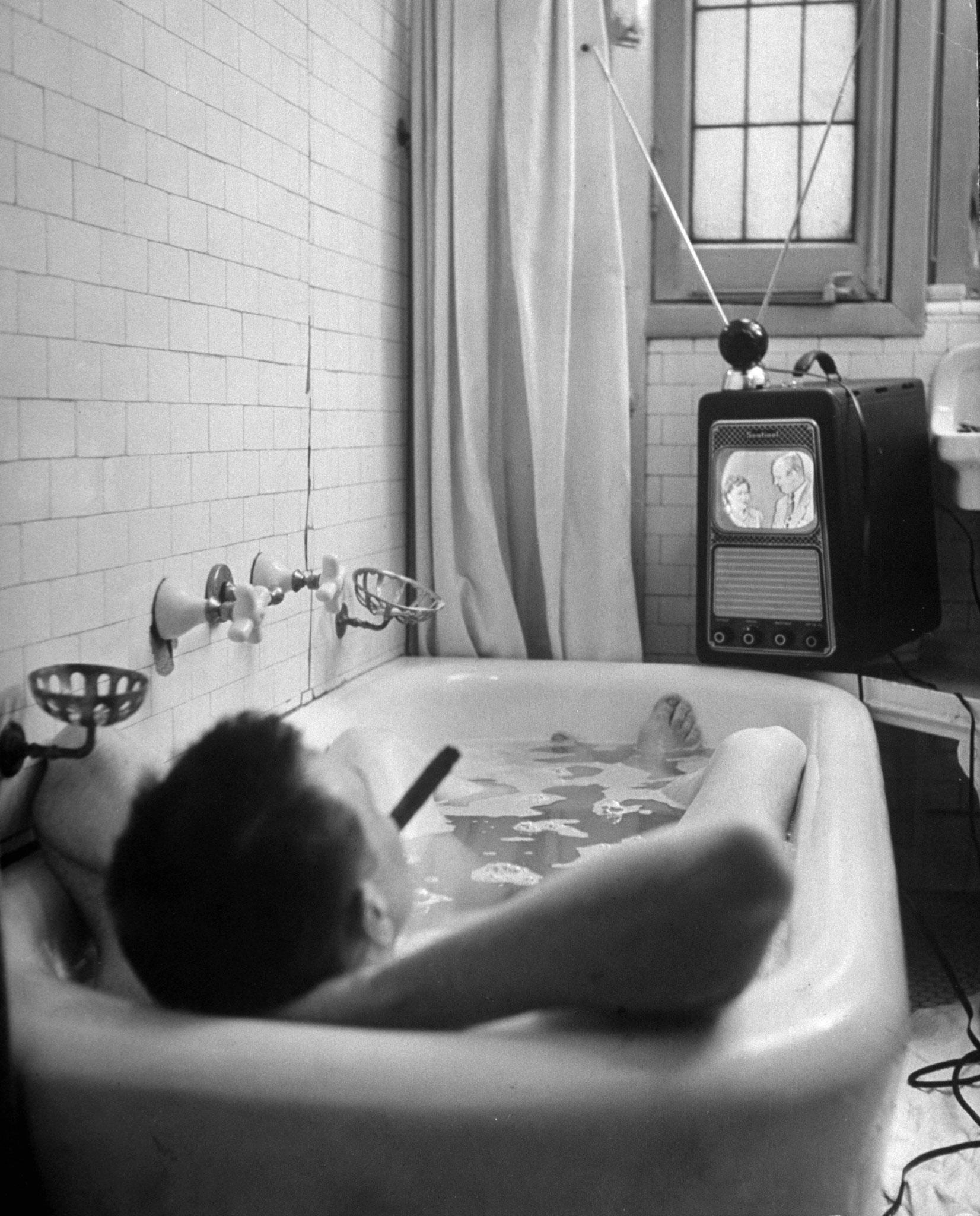 A Man enjoys a smoke, a bath and a TV show in 1948. Photograph by George Skadding for Life Magazine.jpg