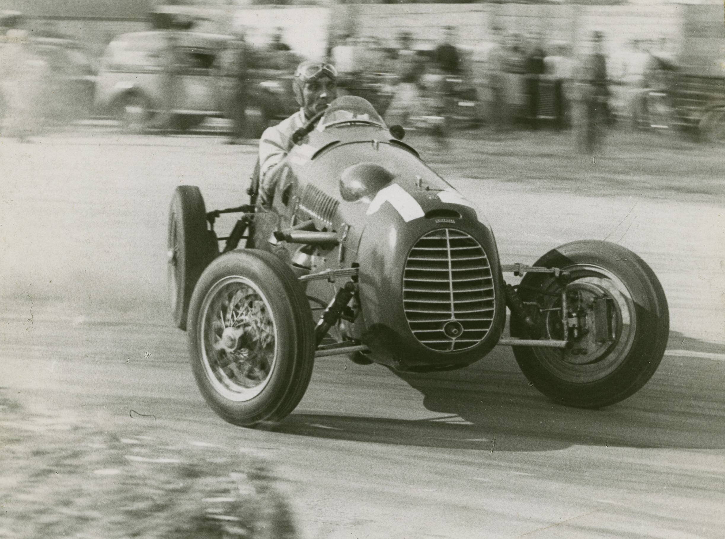 Smoking a Cigarette while catching a massive slide in a formula 1 car. in 1948 you can.jpg