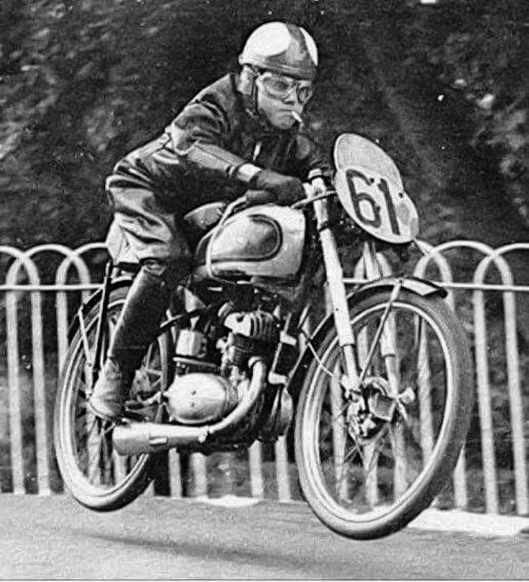 Harvey Williams smoking a cigarette while he's getting some air during the 1952 Isle of Man TT..jpg