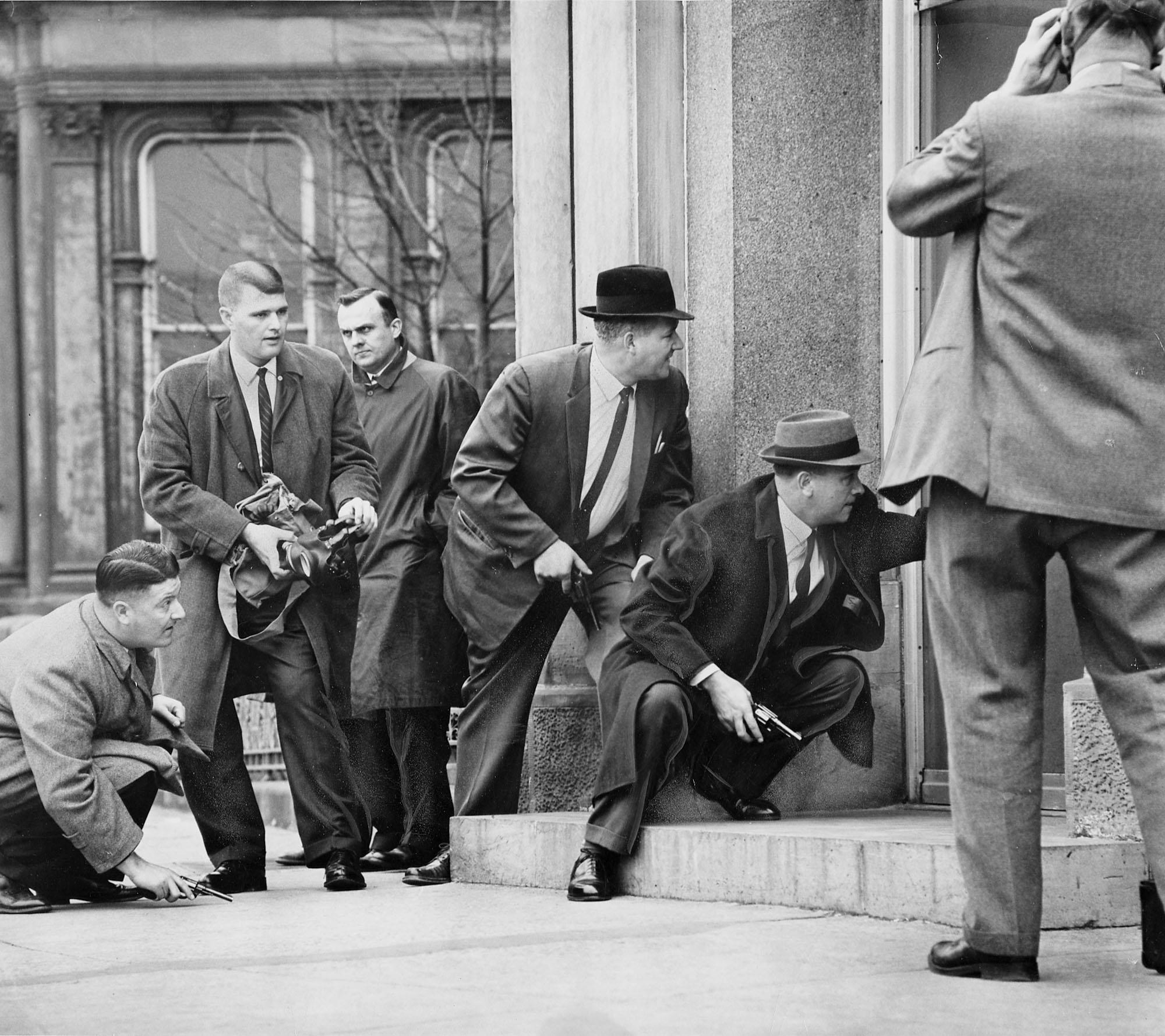 Police detectives prepare to intervene in a bank robbery, 1962.jpg