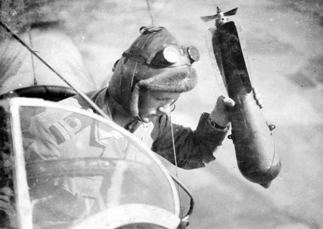 English military aviator dropping bombs, the Western Front, c. 1916.jpg