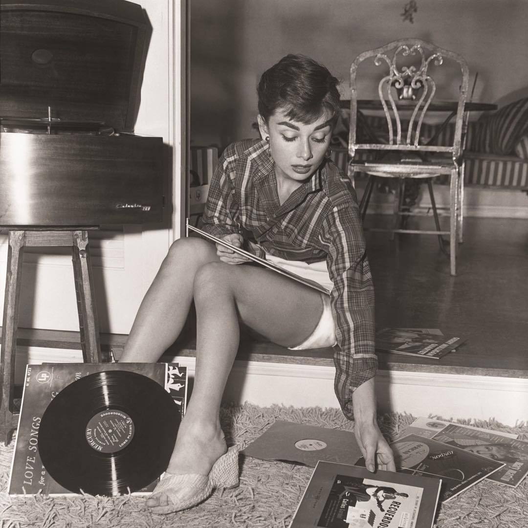 Audrey Hepburn and her record collection, (1950s).jpg