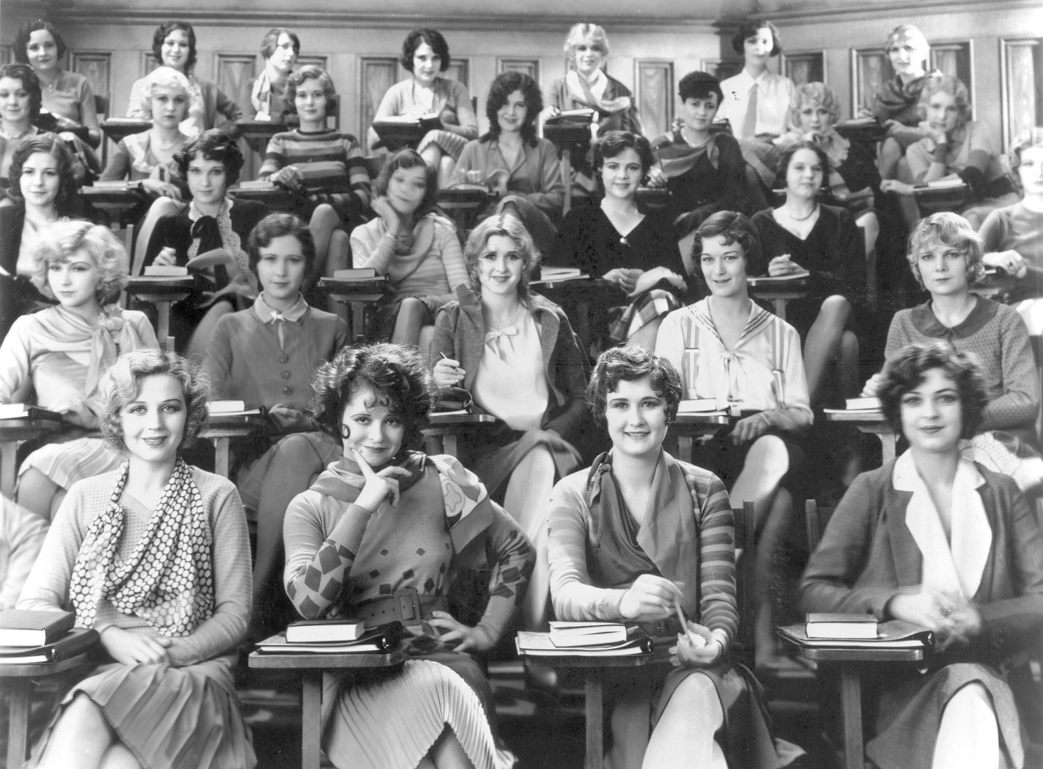 American actress Clara Bow (second from left, front row) in a movie still from the 1929 movie Wild Party.jpg