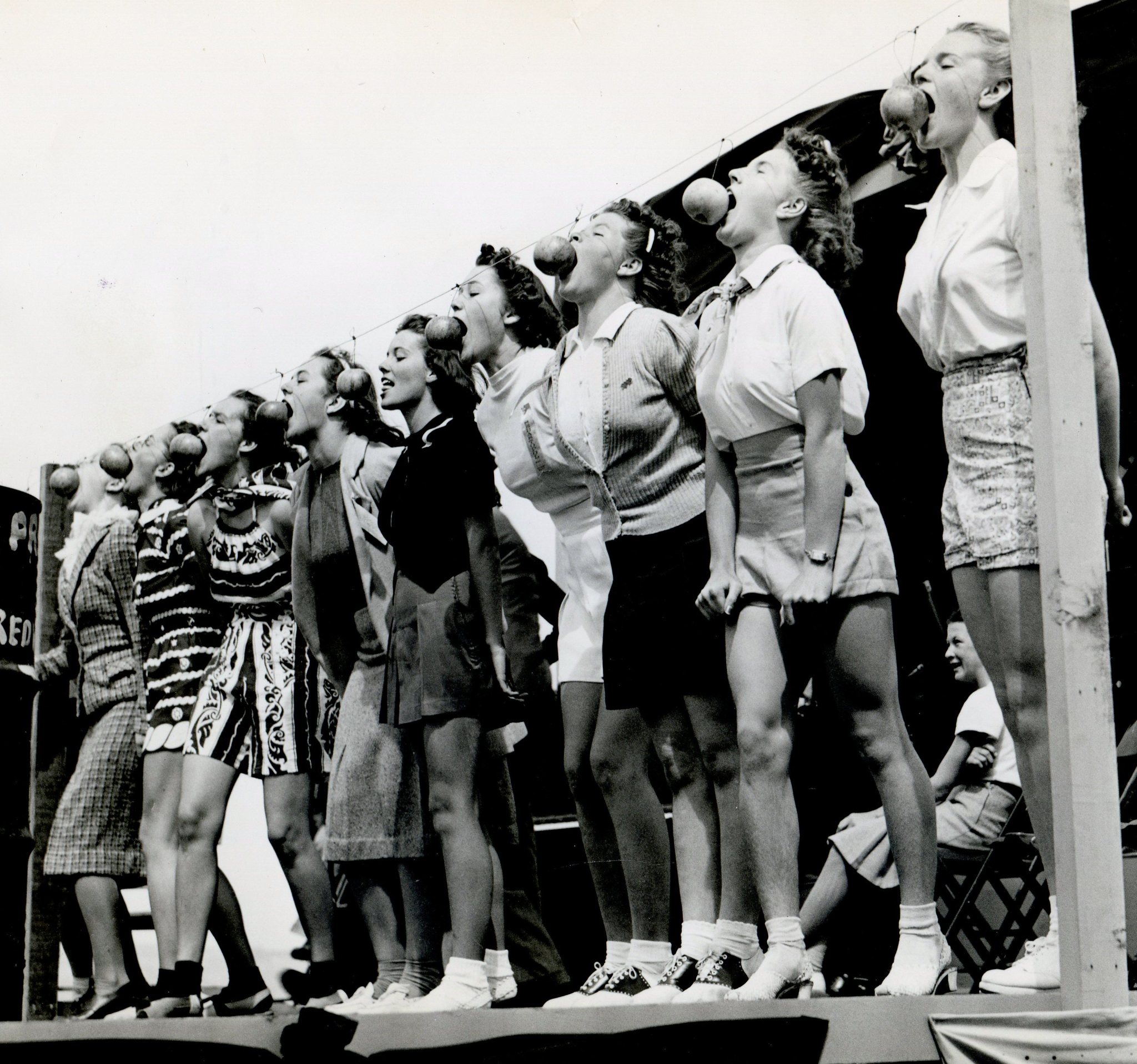 Young women at an apple bobbing contest in Sebastopol. California, 1939.jpg