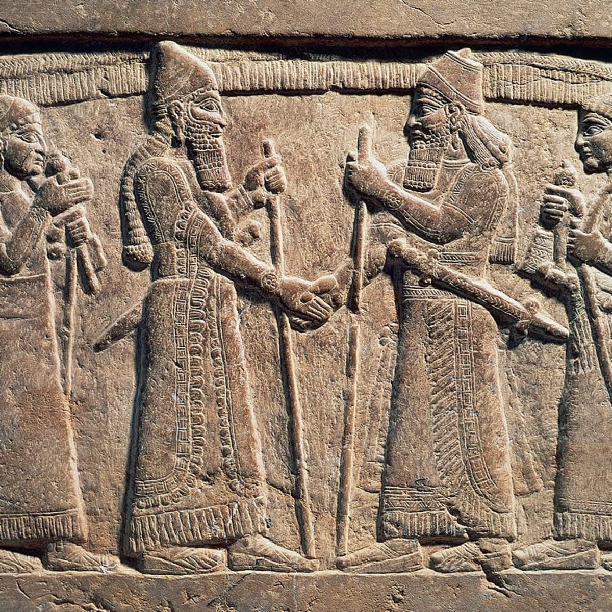 One of the earliest handshakes found in a ninth century B.C. relief, which shows the Assyrian King Shalmaneser III with a Babylonian ruler.jpg