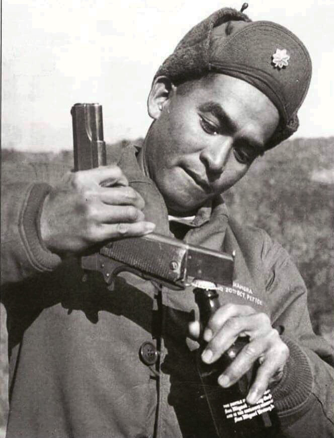 A Filipino officer from the 20th Battalion Combat Team using an m1911 to crack open a cold one. Korean War, 1951-1952.jpg