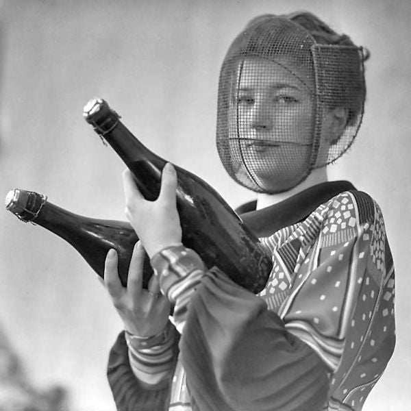 A champagne inspector wearing a special mask to protect against accidental discharges, 1916.jpeg