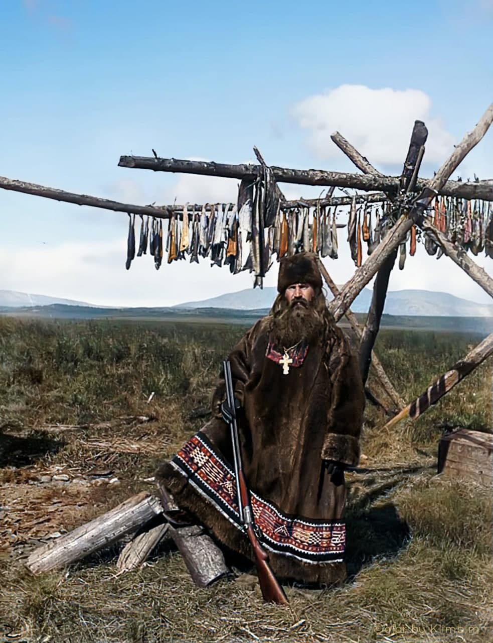 An Orthodox priest in a deerskin cassock and carrying a gun. Gizhiga, Russia 1901.jpg