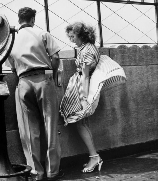 Wind vs skirt on top of the Empire State Building (c. late 1940s).jpg