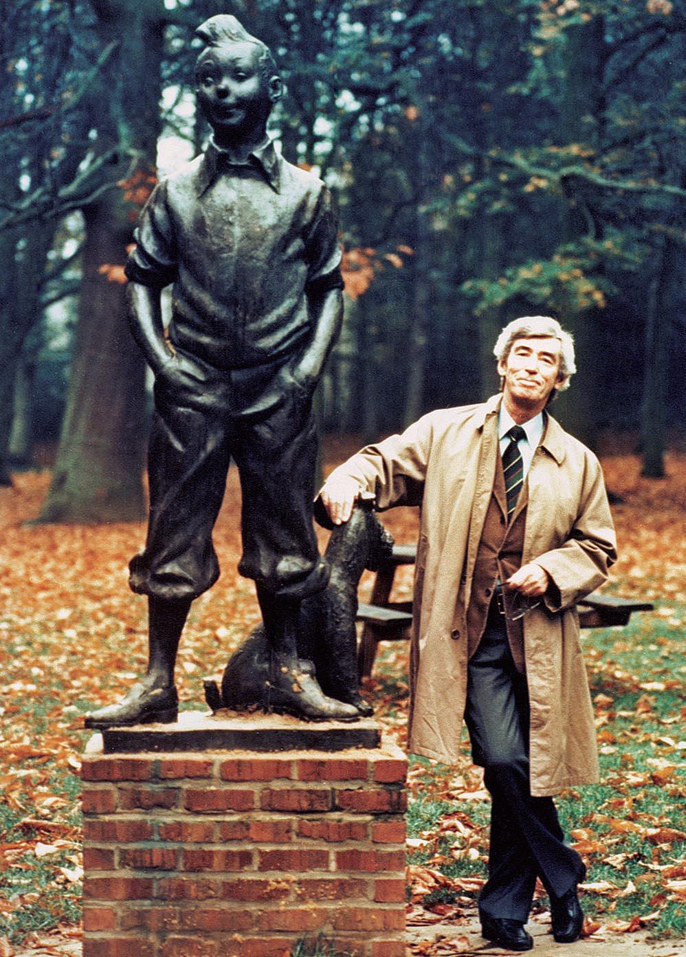 Hergé, the creator of The Adventures of Tintin, celebrating the 50th anniversary of the character, next to a bronze statue of Tintin and Snowy. Belgium, 1979.jpg