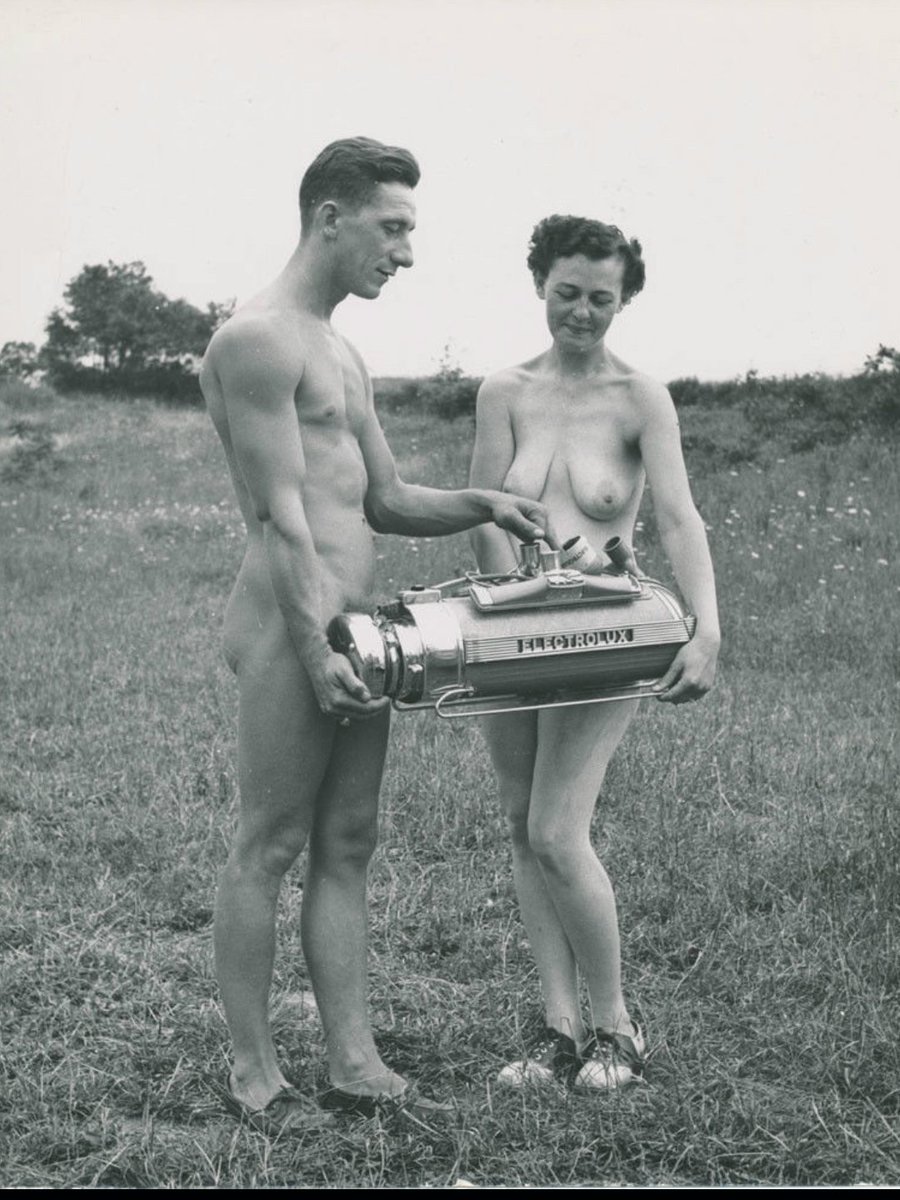 Electrolux salesman holding a Model 30 vacuum cleaner at a nudist camp. Sweden, 1937.jpg