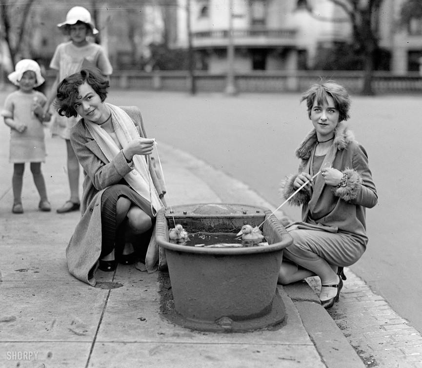 Girls walk ducklings in a drinking bowl. Washington, 1927.jpg