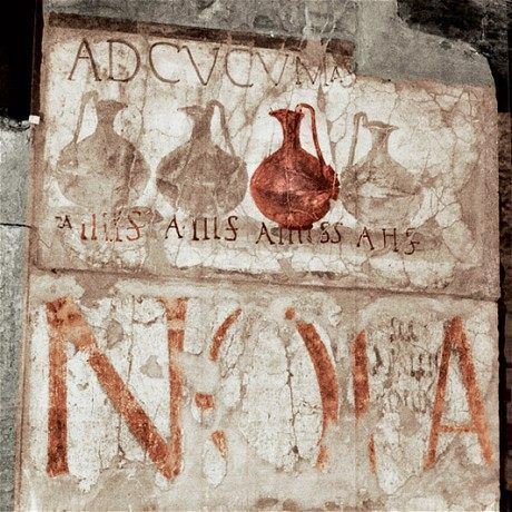 Advertising signboard of the Roman wineshop in Herculaneum, promoting different types of wine and prices. Ad Cucumas on the signboard is probably the name of the place.jpg