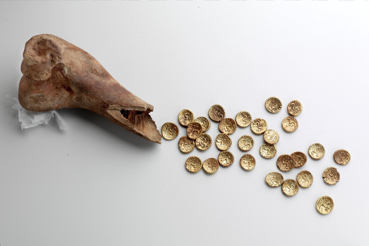 32 Gallo-Belgic E gold coins discovered hidden inside of a cow's bone at Sedgeford, Norfolk  - The coins were made by the Ambiani tribe of Gaul (Southern France) who fought against Julius.jpg