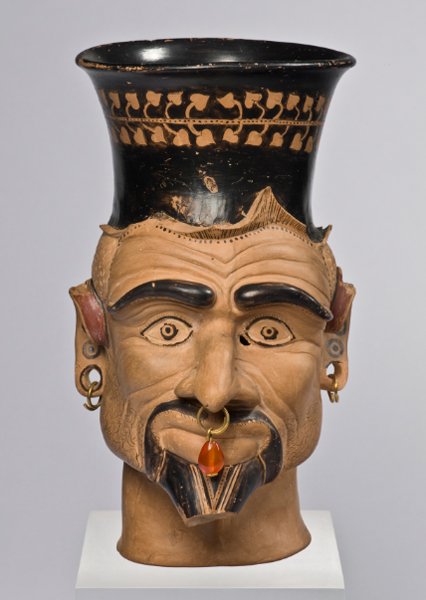 An Etruscan cup with head of Charun, one of the psychopompoi of the underworld. 400-300 BCE.jpg