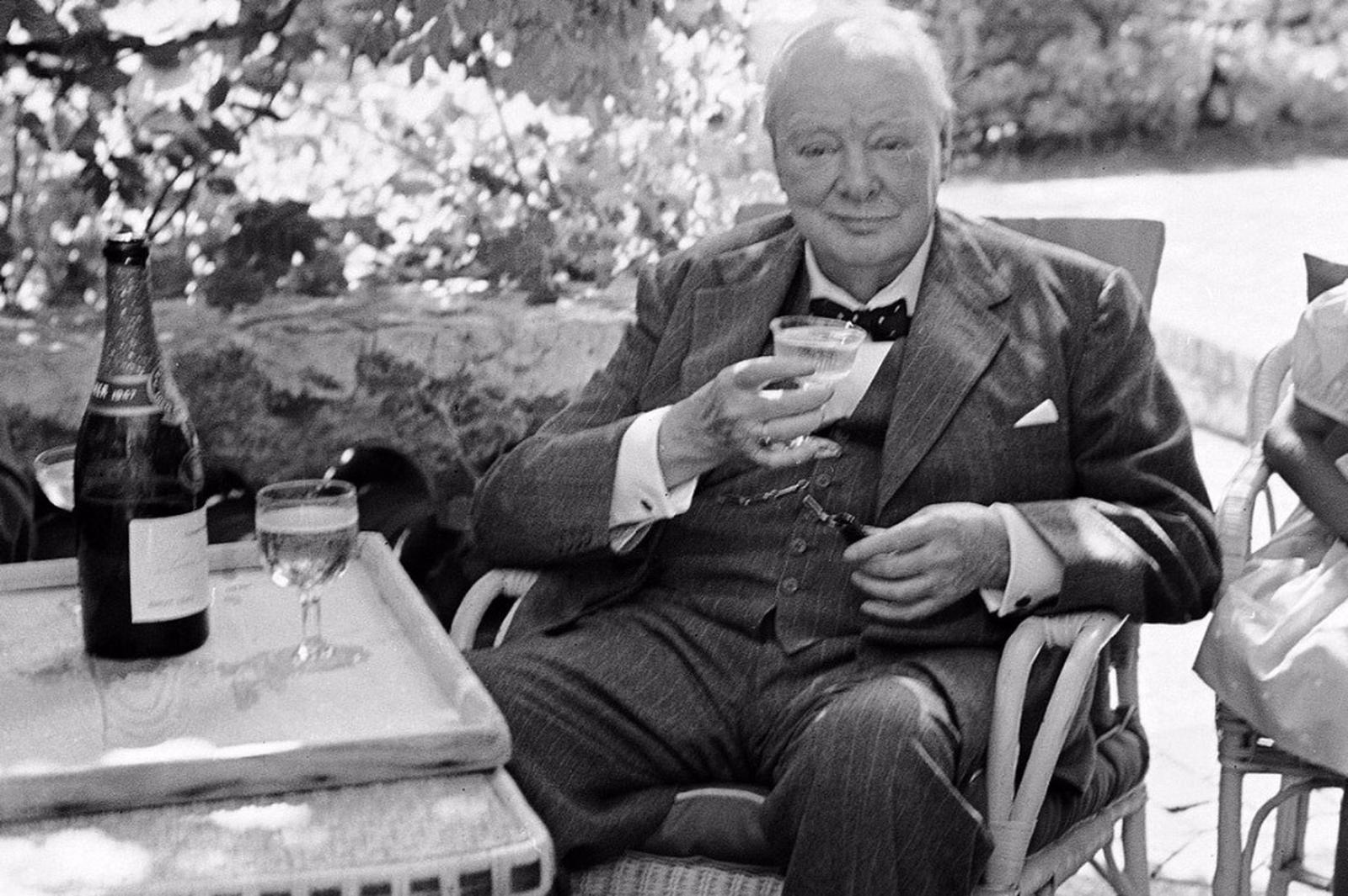 Winston Churchill indulges himself with a glass of champagne (1940s).jpg