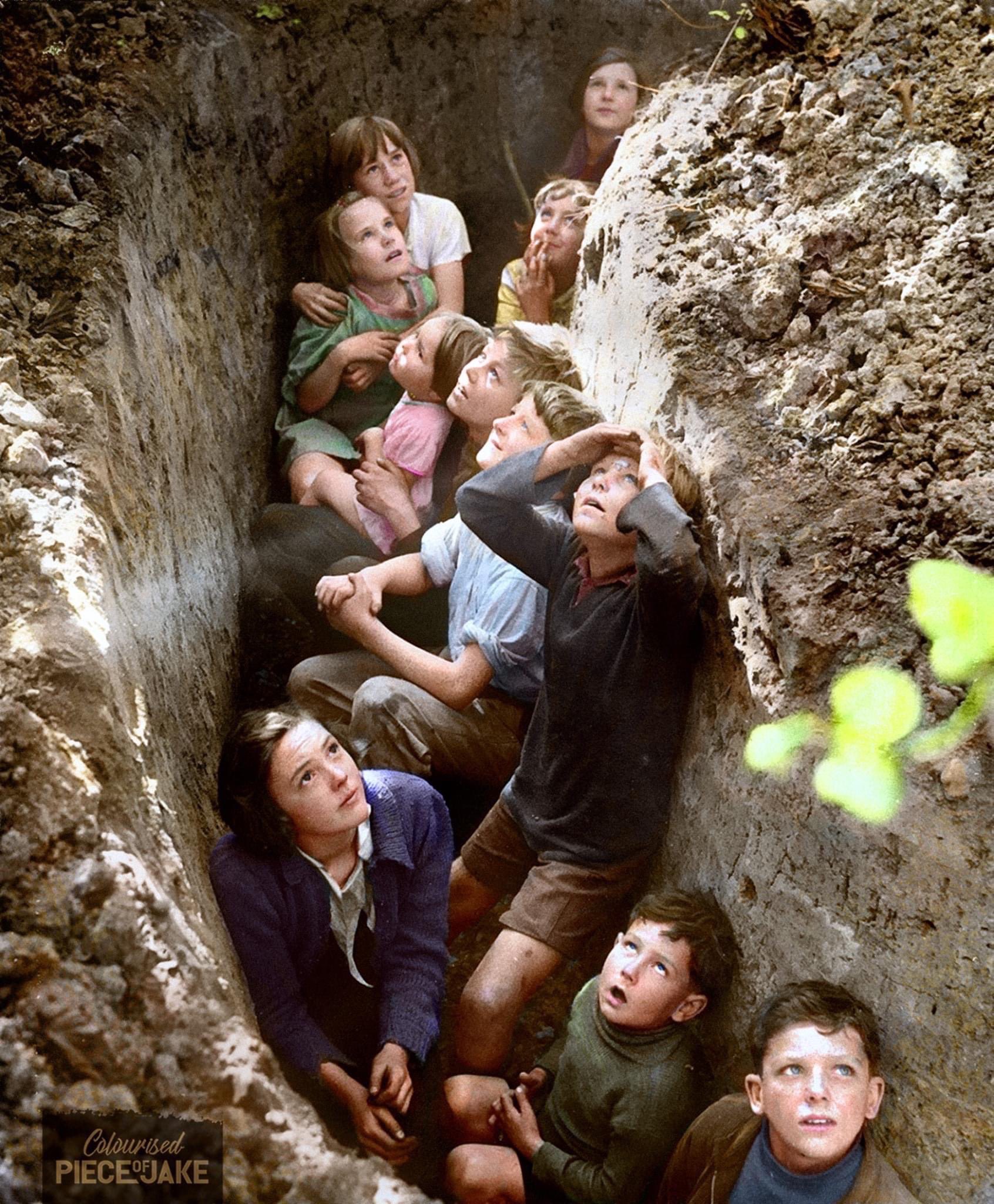Children from London, hiding in a trench in Kent, watching German planes overhead, during the battle of Britain. John Topham (1940).jpg