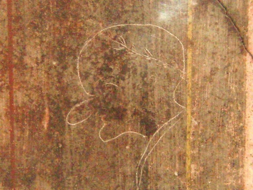 Roman caricature - Located in the Villa of Mysteries, Pompeii. The Latin text above the figure reads ‘Rufus est’ (This is Rufus).jpg
