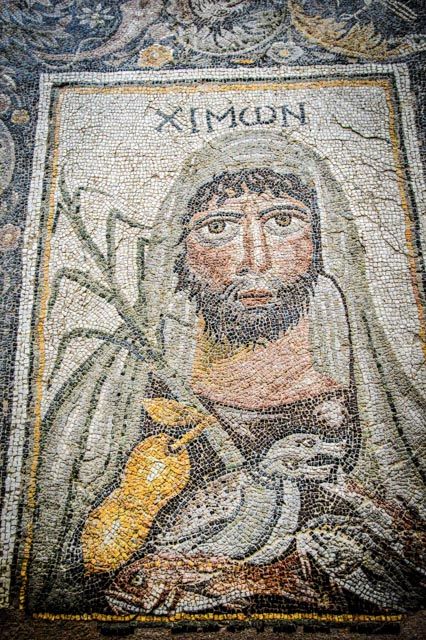 Roman mosaic showing winter. Object known as the Four Seasons Mosaic is located in Villa of the Falconer, Argos (Greece). Dated back to V century CE. On mosaic we can see written in ancient greek – Chimon, so 'winter'.jpg