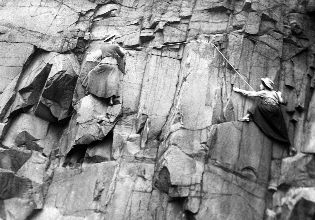 Lucy Smith and Pauline Ranken of the Ladies Scottish Climbing Club, climbing the Salisbury Crags cliff in Edinburgh. 1908.png