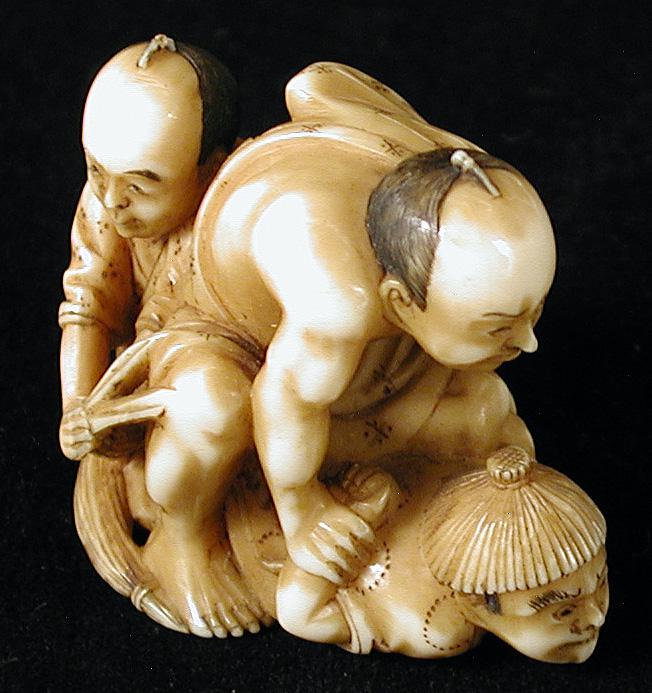 Ivory carving of two men capturing a thief. Japan, 19th century.jpg