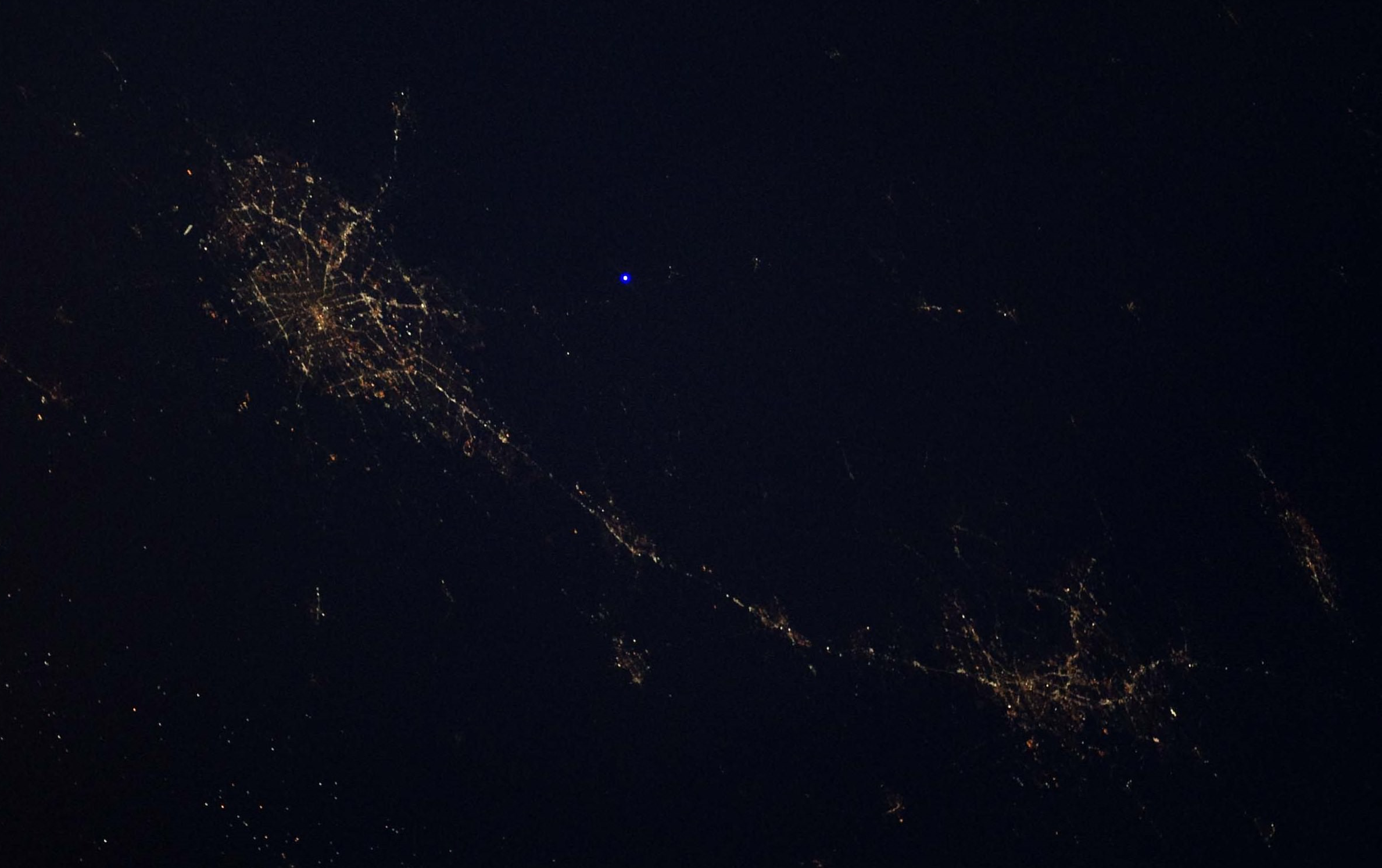 Regular consumer grade handheld blue laser pointer -- as seen from the International Space Station.png