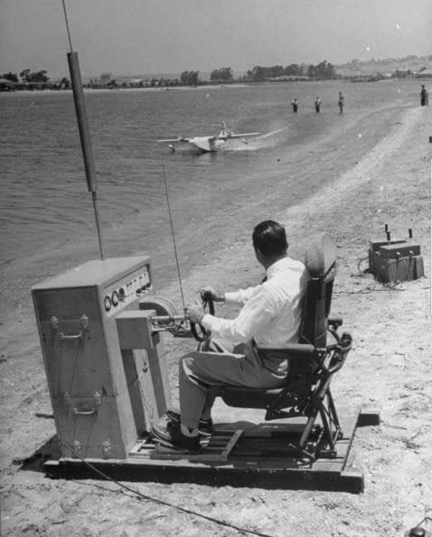 Howard Hughes operating a large remote control console for a RC model of his Spruce Goose flying boat. Circa mid 40s.png