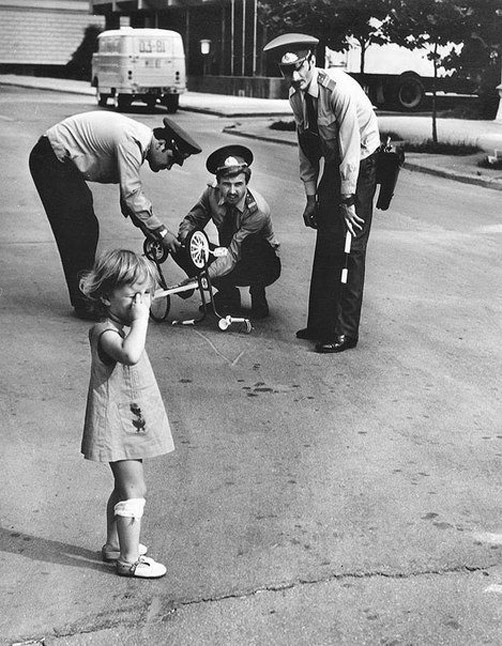 Police officers repairing the girl's broken bicycle. Baku, 1980.jpg