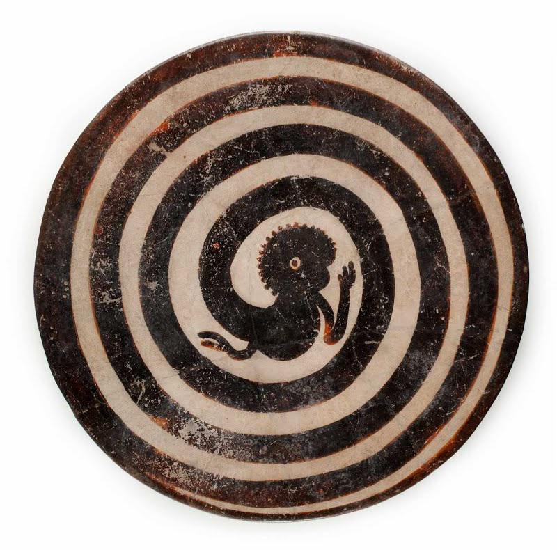 A Maya plate with monkey tail in a spiral. 300-850 CE, now on display at the National Museum of Anthropology in Mexico City.jpg