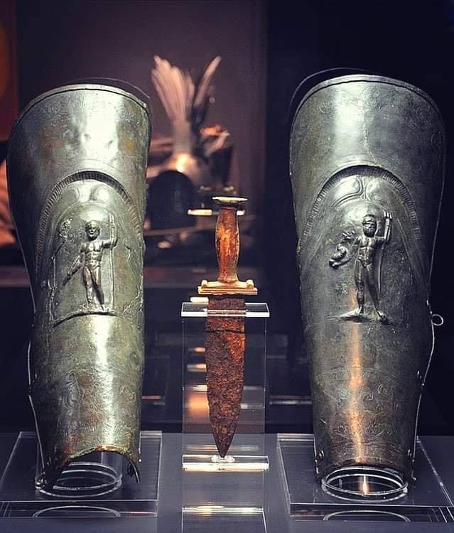 dagger and pair of greaves (shin guards) belonging to a gladiator, discovered at Pompeii. The bronze greaves depict Jupiter and Neptune and the dagger is decorated with ivory. 1st century AD.jpg