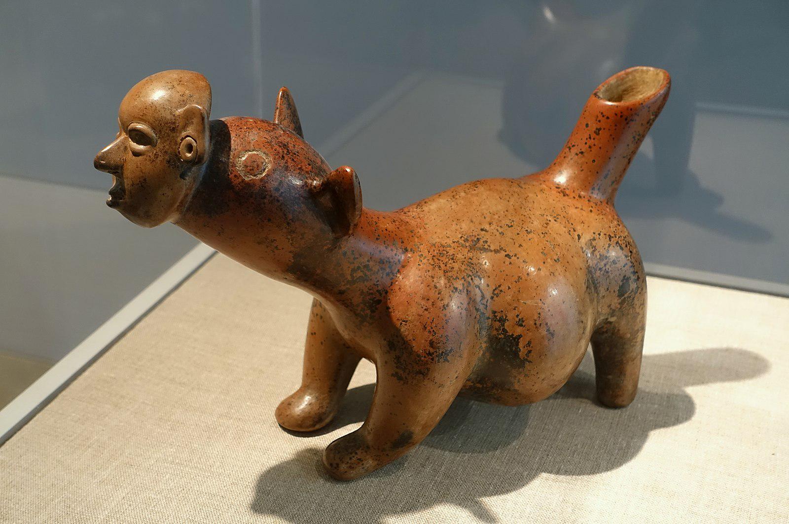 Sculpture of a dog wearing a human mask. Dates back to c.100 BCE-200 CE. Found in the state of Colima, Mexico.jpg