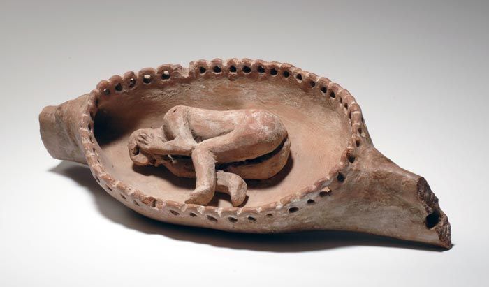 A terracotta sculpture of a deceased person on a funeral boat. From Egypt, 4000-3500 BCE, Naqada I period.jpg