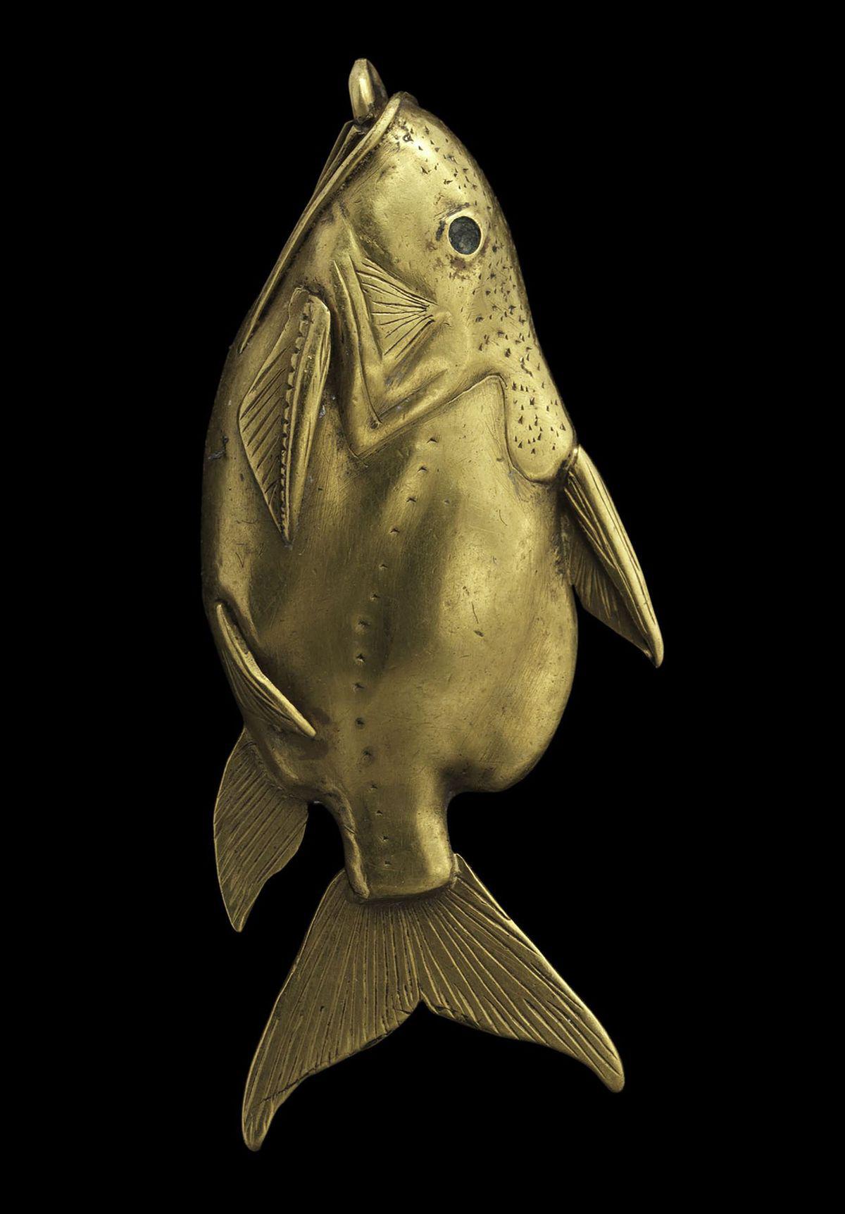An ancient egyptian gold pendant (ca. 1878-1749 BC) in the form of an upside-down catfish, a species that regularly swims belly-up and thus resembles a dead fish. The fish was a popular charm in ancient Egypt believed to ward off drowning.jpg