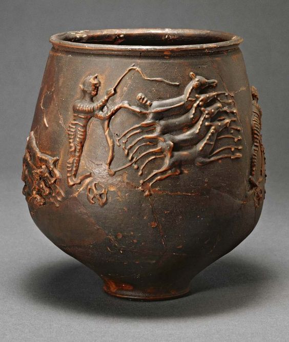 Roman vase from Colchester, showing charioteer racing his quadriga.jpg