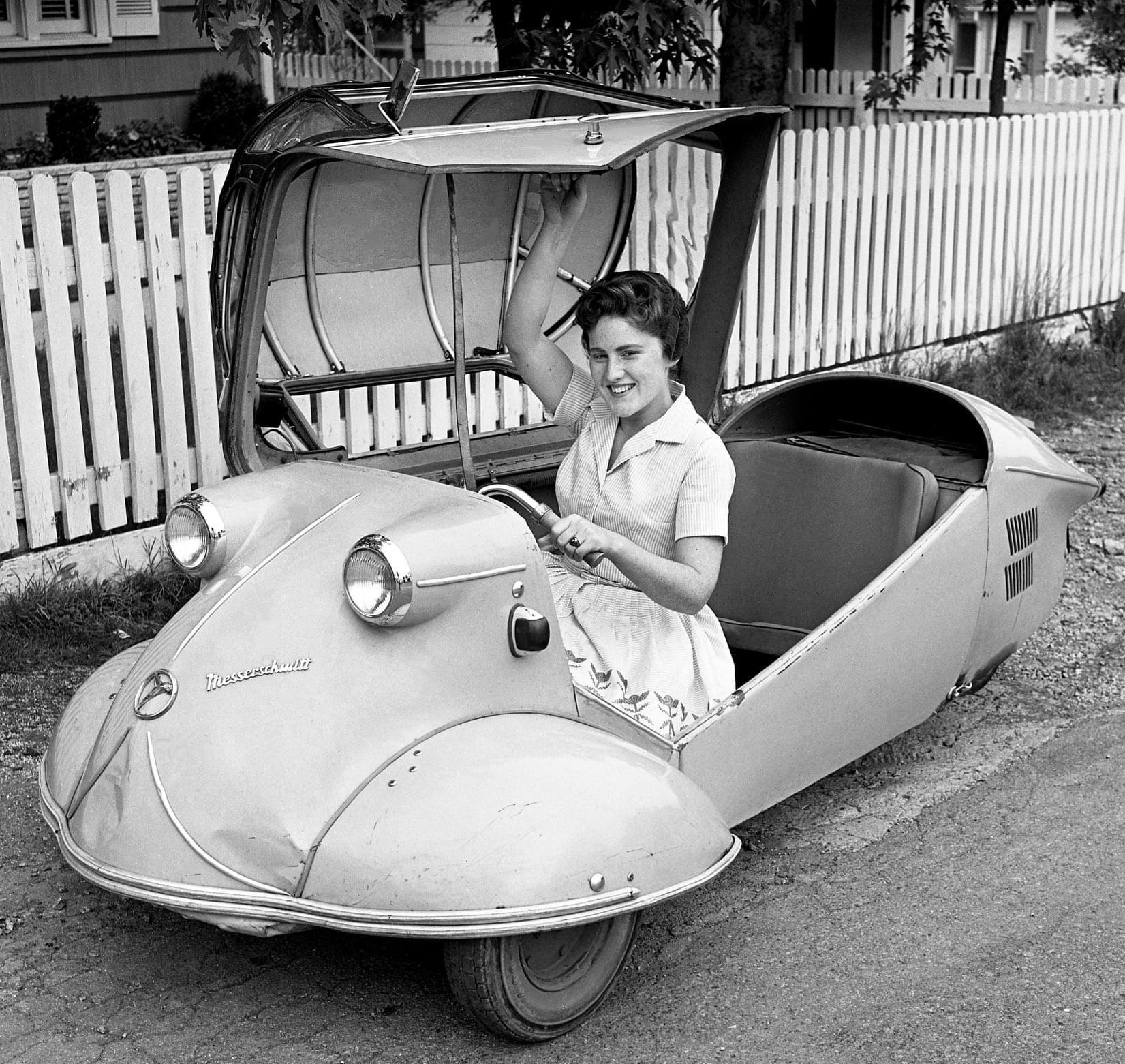 Linda Compton prepares to pulldown the door of her father’s little 1955 model Messerschmitt KR175 car and drive off to Madison High School in Nashville, TN (May 19, 1961).jpg