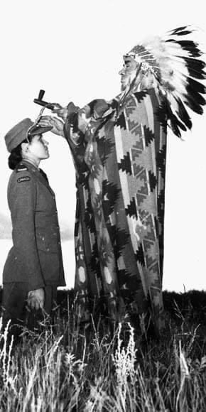 Mary Greyeyes, a Cree woman from Muskeg Lake Reserve, was the first indigenous woman to serve in the Canadian armed forces. Here she is receiving a blessing from Harry Ball of the Piapot Nation, September 29, 1942.jpg