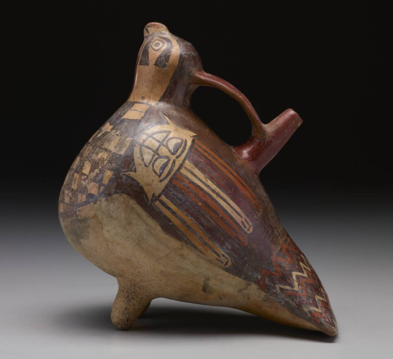 Single-spout-and-bridge bottle in the shape of a falcon with trophy heads, ceramic and slip paints, Nazca culture, 300-500 AD.png