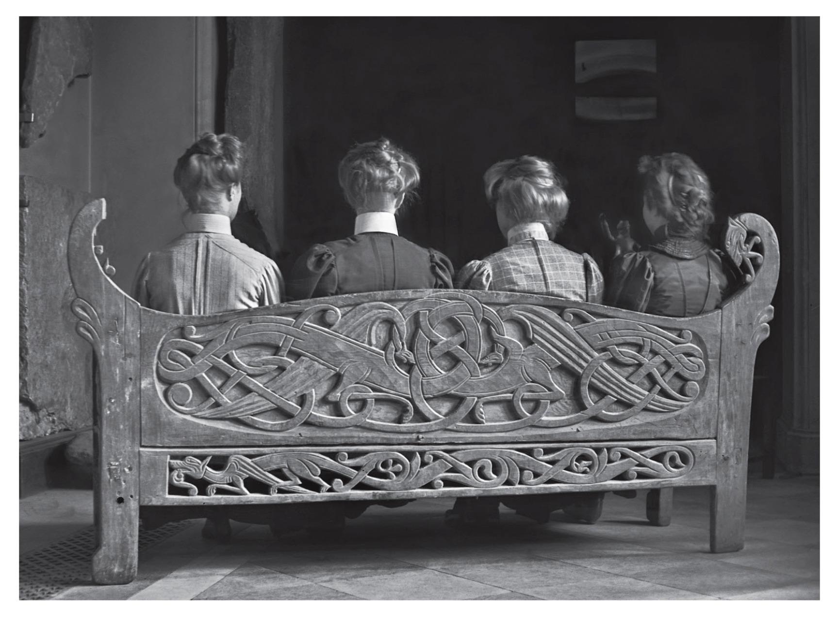 Assistants at the Swedish History Museum, sitting on the 12th century 'Dragons Bench' from Kungsåra church. Stockholm, 1908.jpg