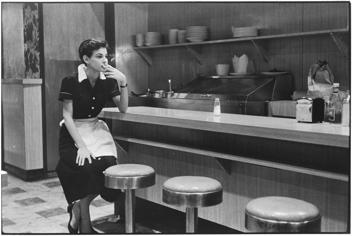 A waitress in a diner taking a break, New York City, 1955.jpg
