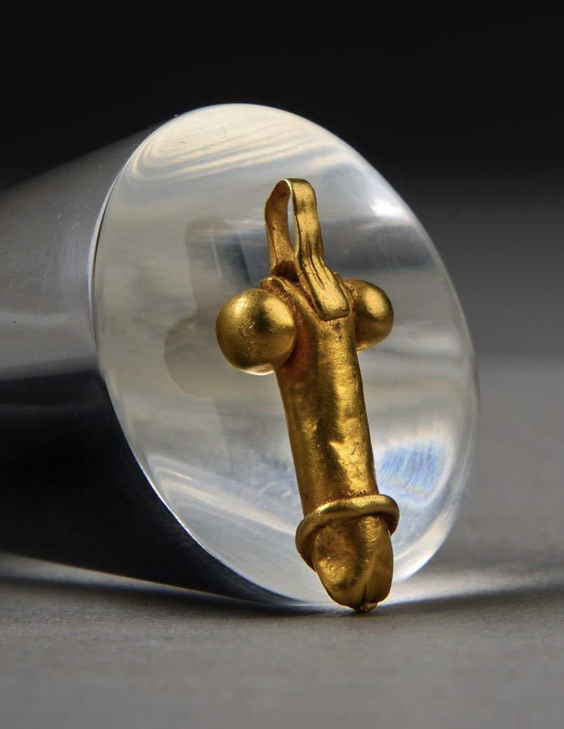 Roman gold phallus pendant, found by a metal detectorist in Hillington, Norfolk in 2011. On display at the Lynn Museum.jpg