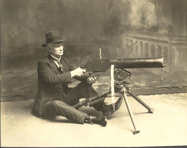 John Browning looking extremely dapper while demonstrating his new heavy machine gun in 1917.jpg